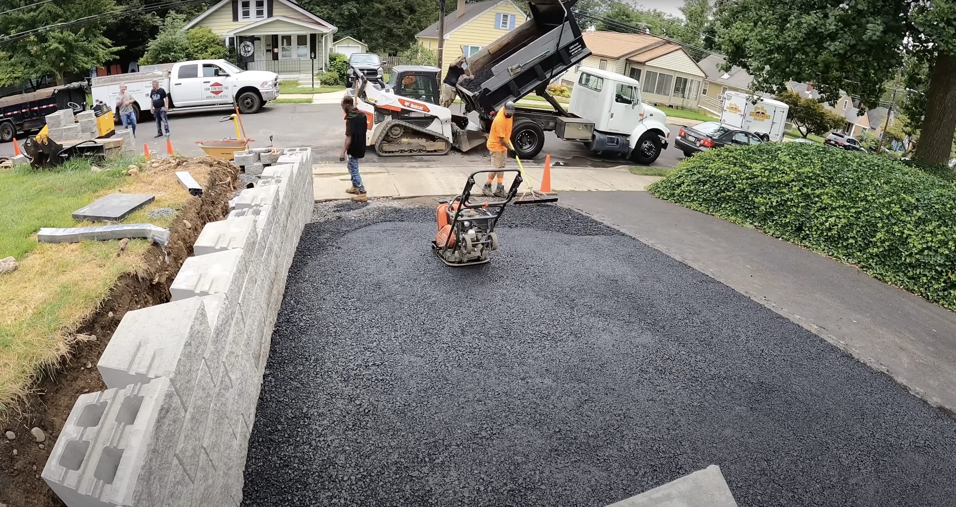 Professional driveway installation in progress by Henderson Concrete Pros team Active residential driveway construction project with equipment and crew working in Henderson, KY