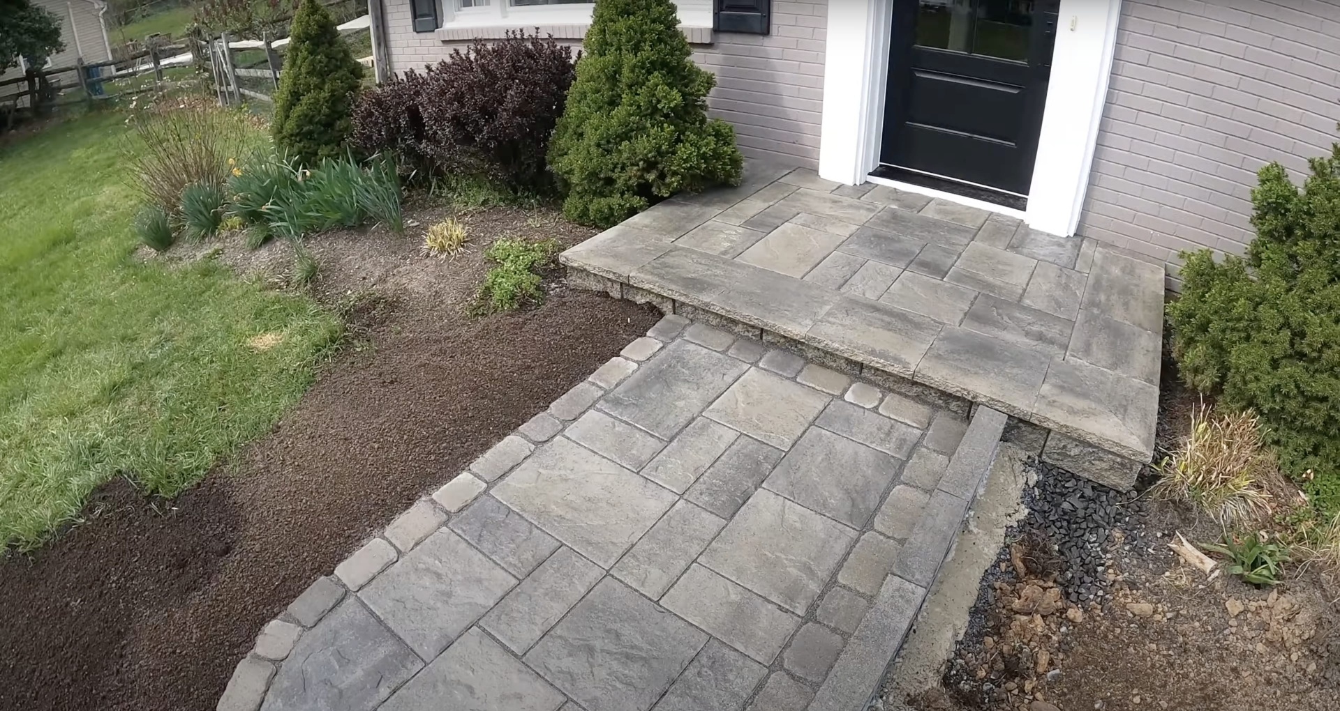 Decorative concrete walkway and entrance by Henderson Concrete Pros Elegant paver-style concrete walkway and entrance installation in Henderson, KY