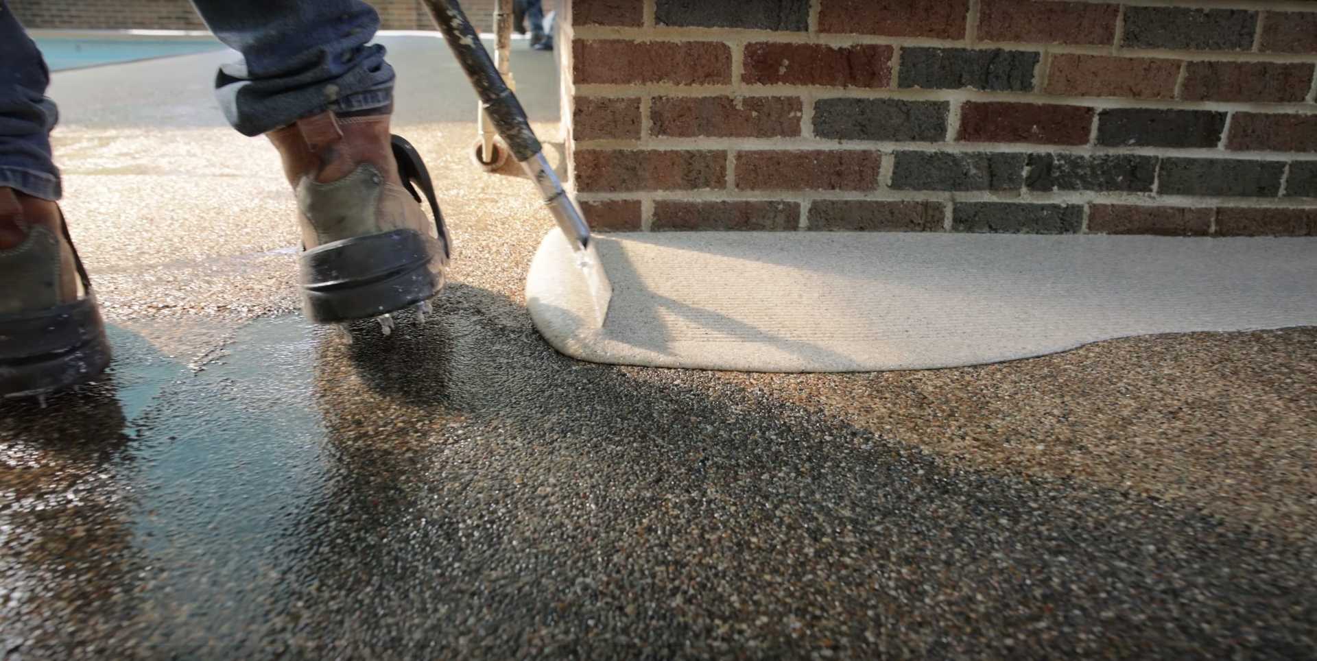 Expert concrete finishing by Henderson Concrete Pros team Professional concrete finishing work showing smooth trowel technique on residential driveway in Henderson, KY