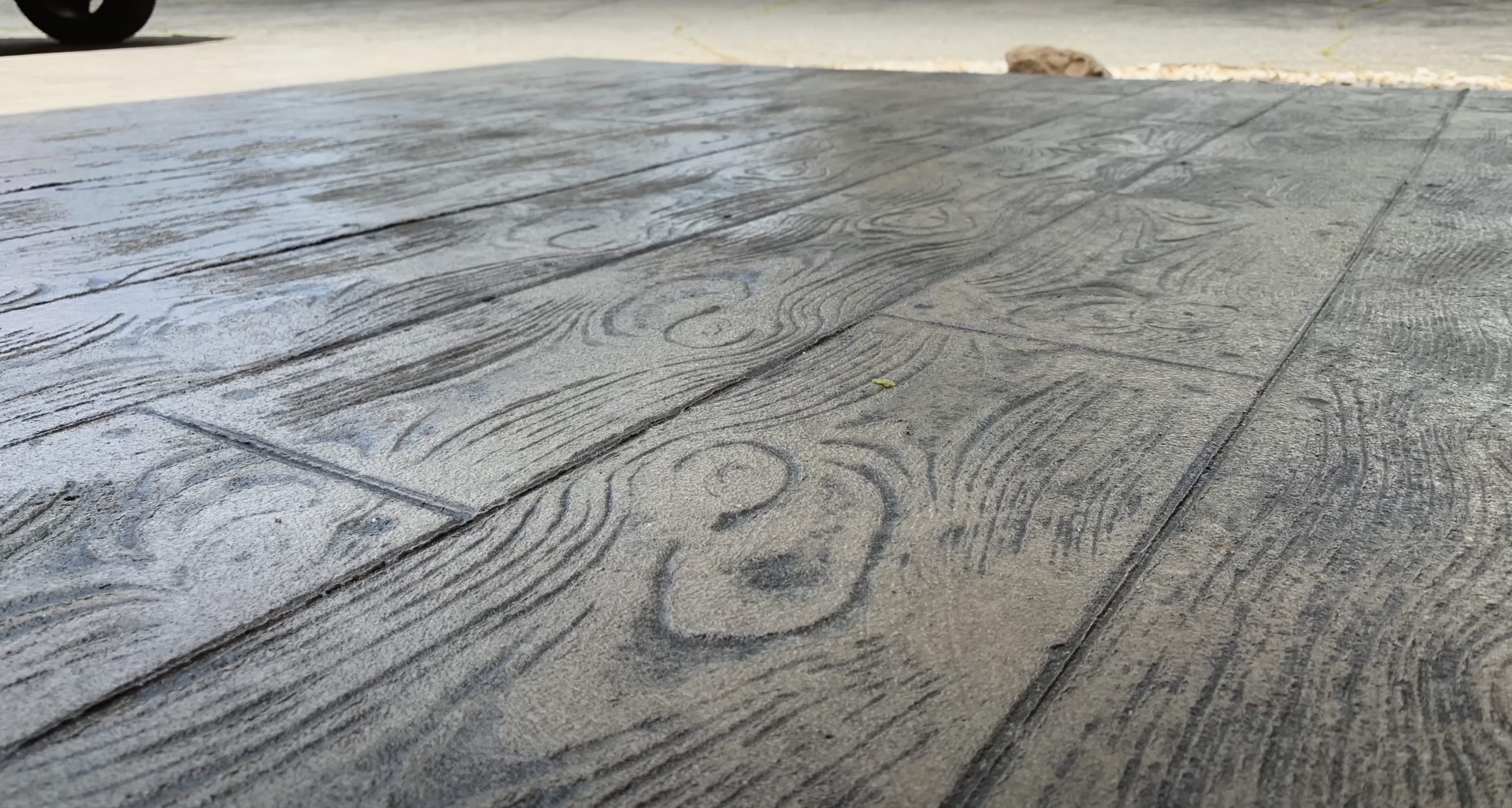 Wood-grain stamped concrete driveway by Henderson Concrete Pros Beautiful wood-grain stamped concrete driveway installation showing decorative pattern work in Henderson, KY