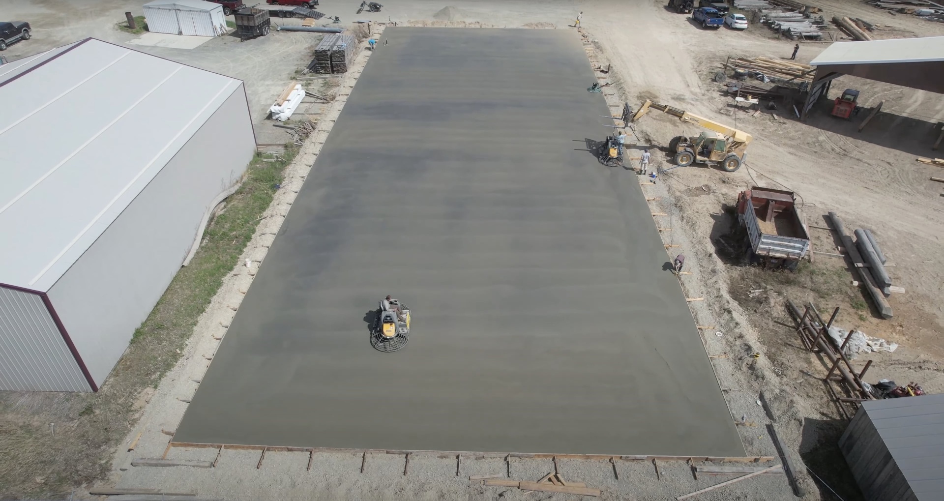Commercial concrete installation project by Henderson Concrete Pros Large-scale commercial concrete slab installation aerial view showing professional equipment and crew in Henderson, KY